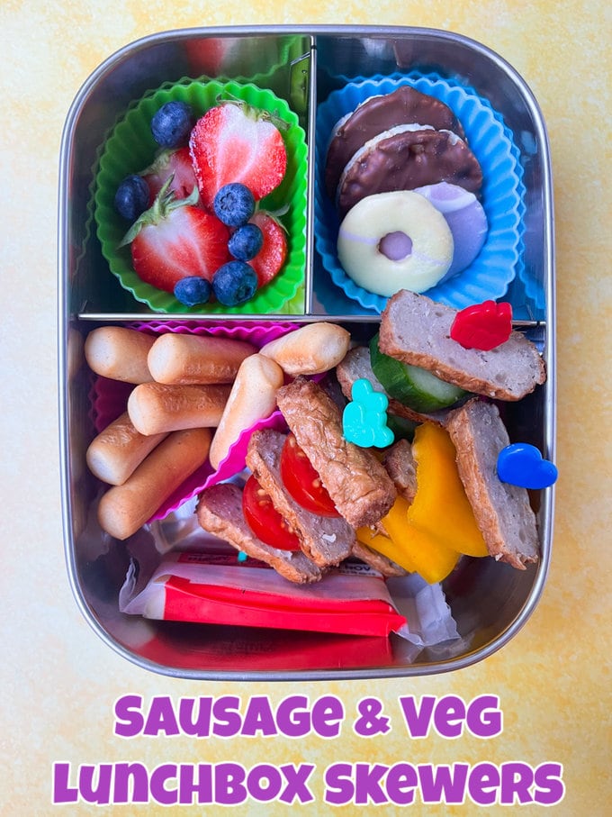 Sausage & veg skewers served in a tin divided lunchbox.
Skewers held together with colorful Pick Sticks. Skewers are presented with fresh berries,mini bread sticks and a portion of cheese.