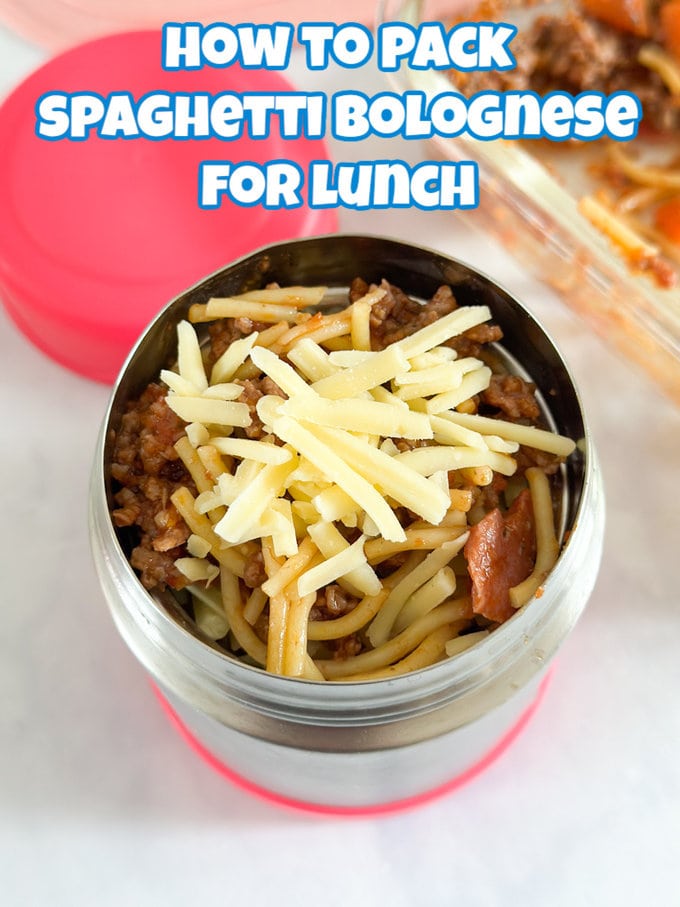 Spaghetti Bolognese packed into a kids thermos topped with grated cheddar cheese.
